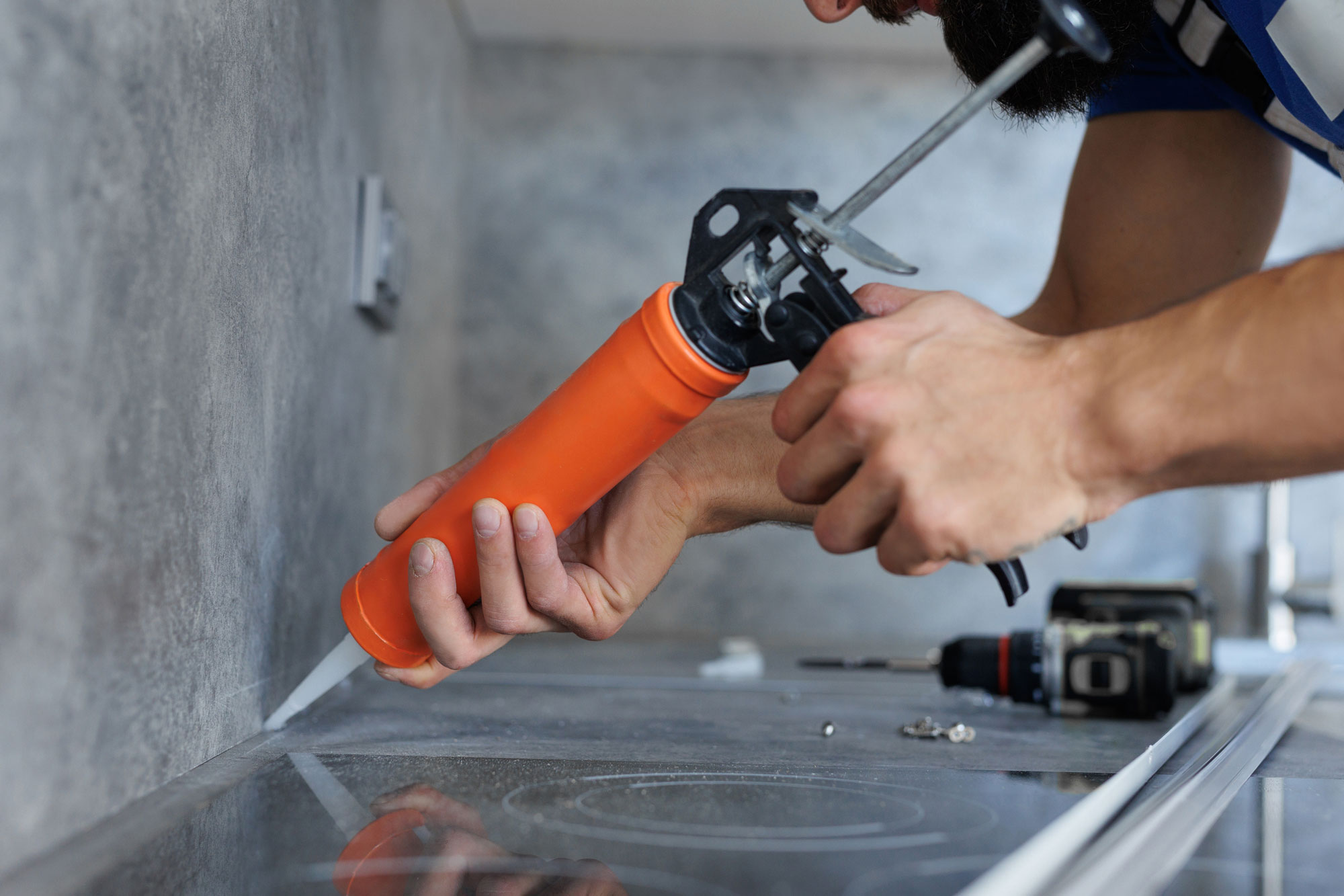 Picture of a Construction Worker Caulking in a Kitchen